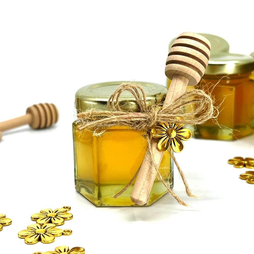 Assembled honey favor with flower charm and honey dipper tied with jute string